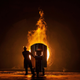A worker takes samples for quality of molten iron in a steel furnace.